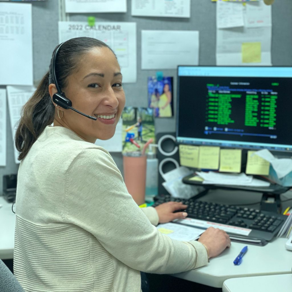 Female Customer Service Representative Smiling at Desk