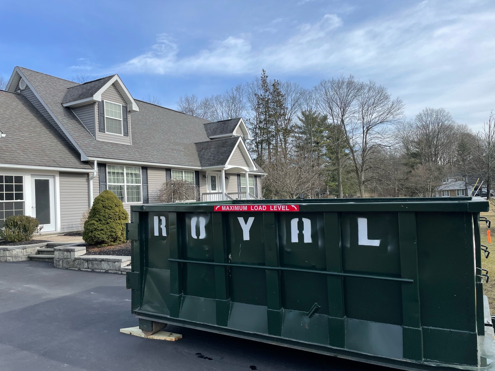 Royal Carting roll-off dumpster outside a residential home