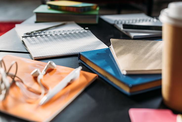 Notebooks and books on a black table