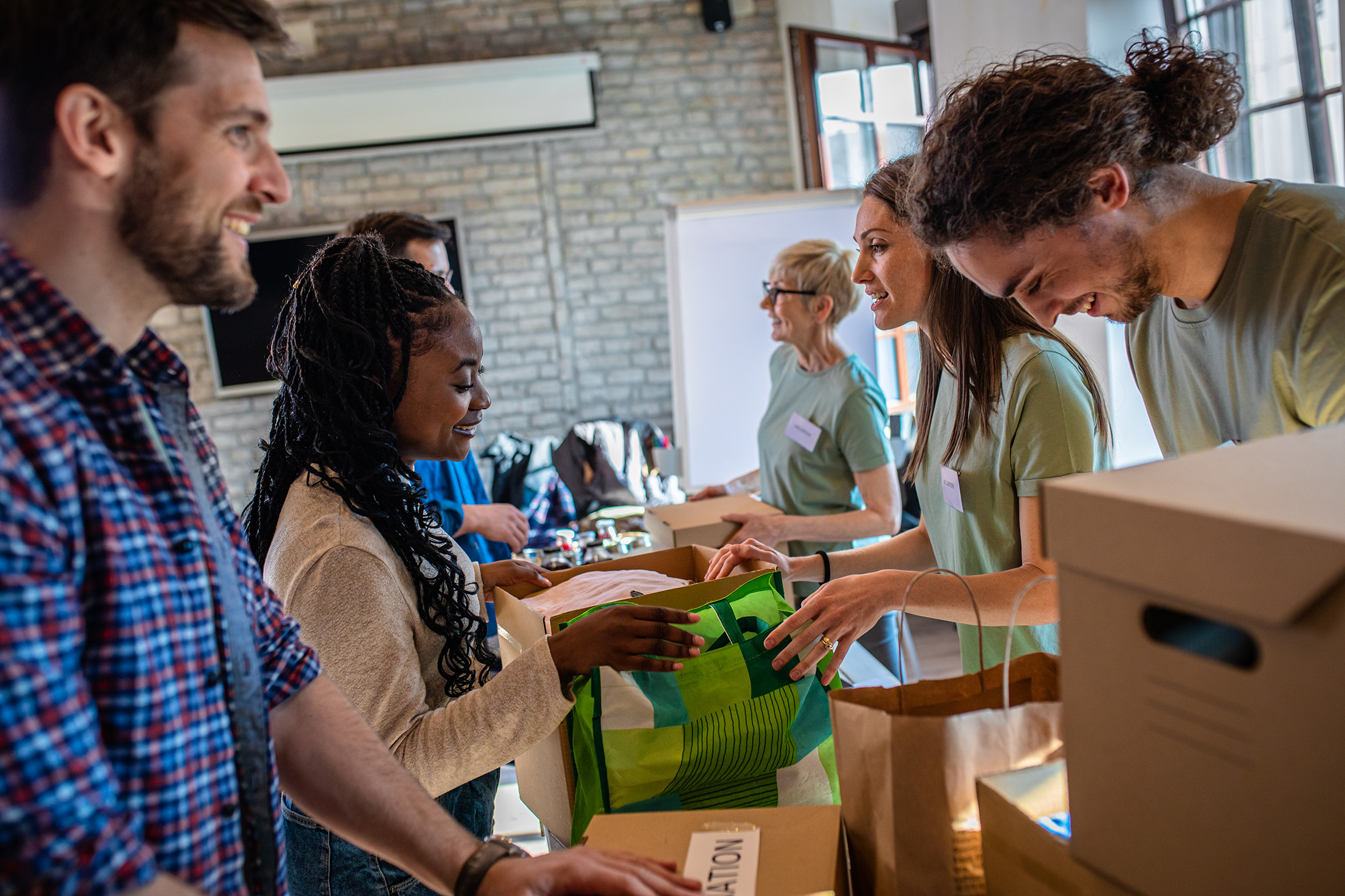 Group of volunteers working in community charity donation center.